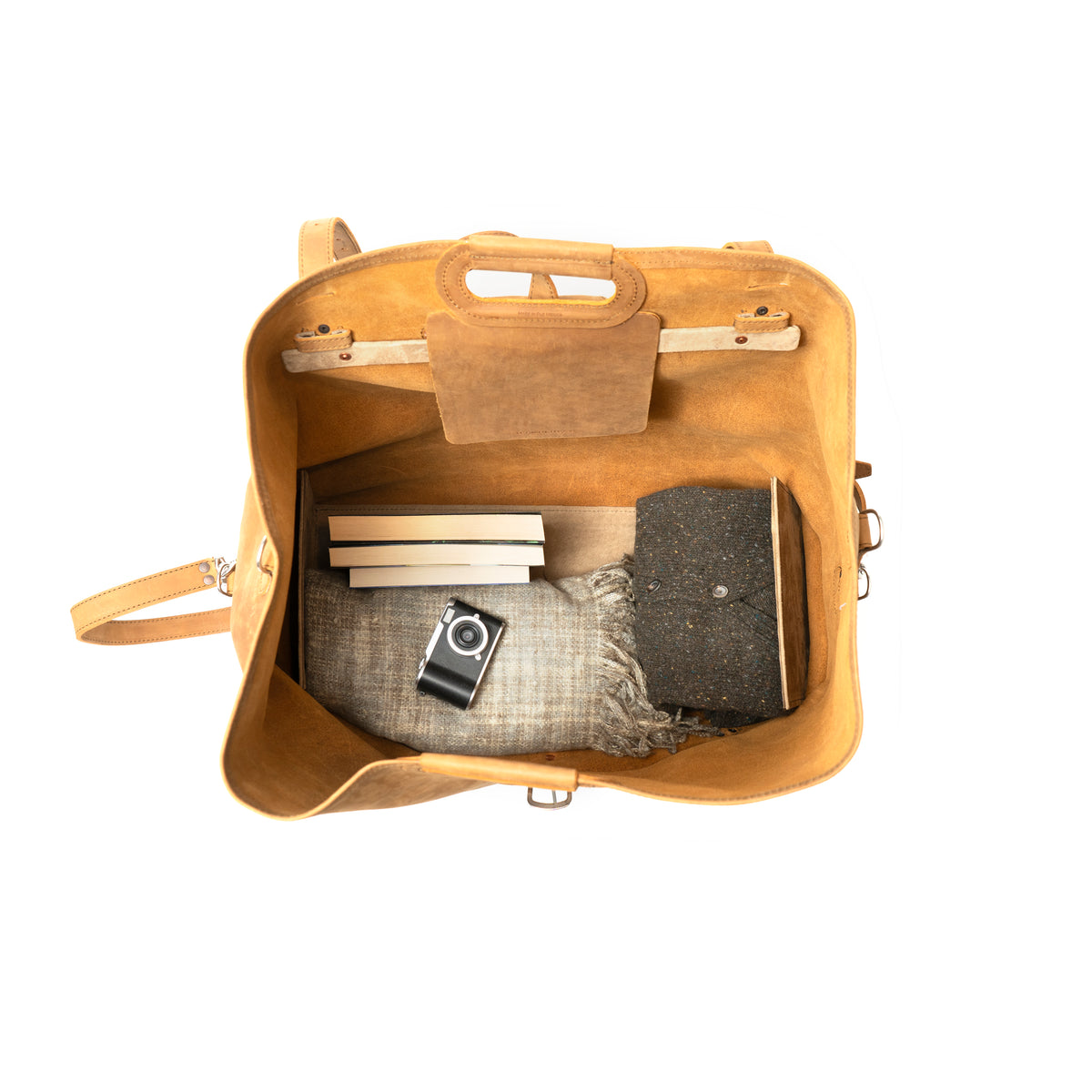 24" Waterbag in tan, top-down view inside packed with blankets, books and a camera