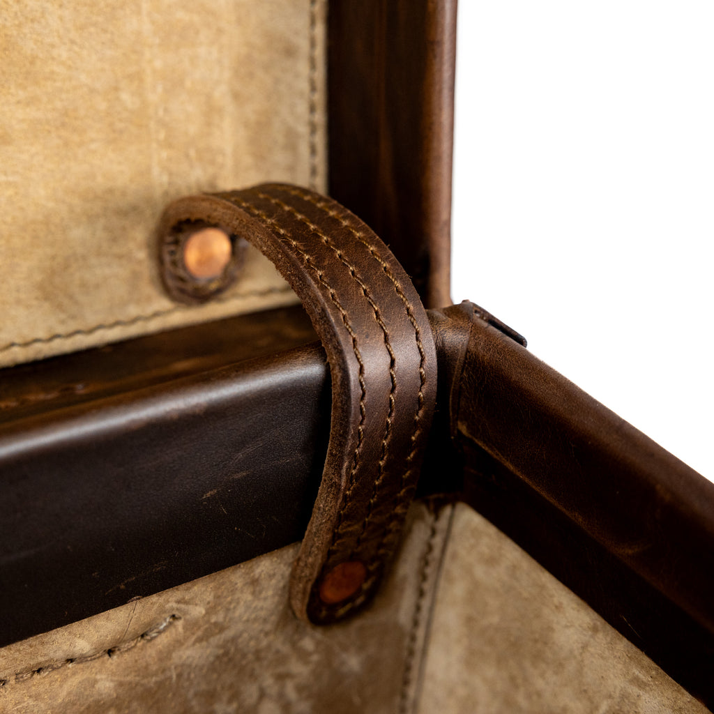 Grandfather Carry On in Dark Coffee Brown, close-up of the stitched interior lid strap with copper rivets