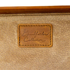 Grandfather Carry On in Tobacco, close-up of the embossed Grandfather Collection leather patch on the lining