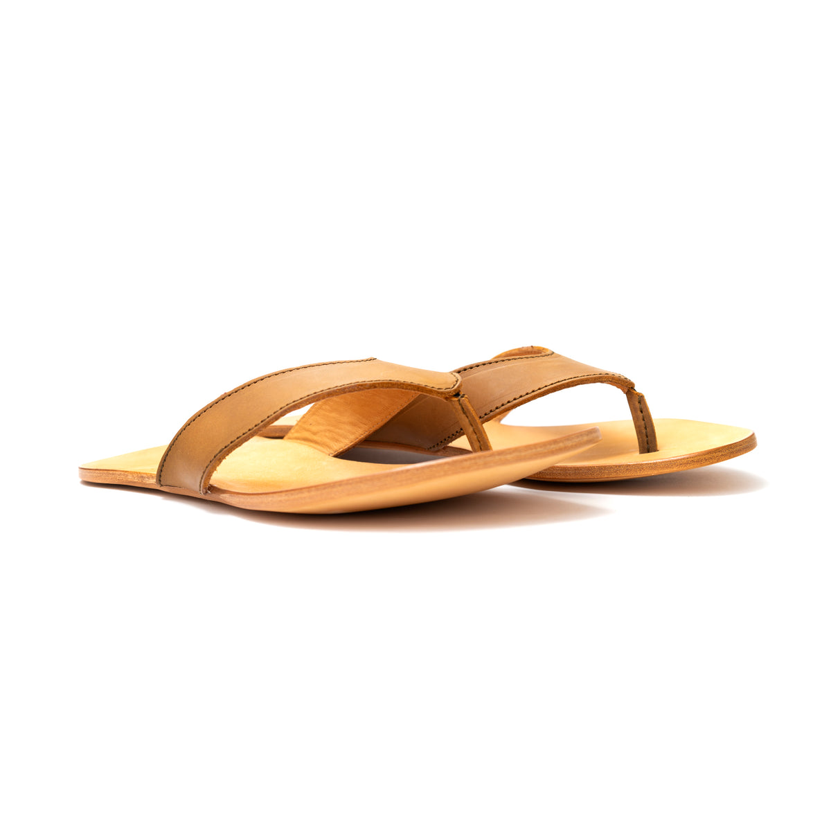 Pair of Flip Flops in Tobacco leather with natural footbeds, low side angle view