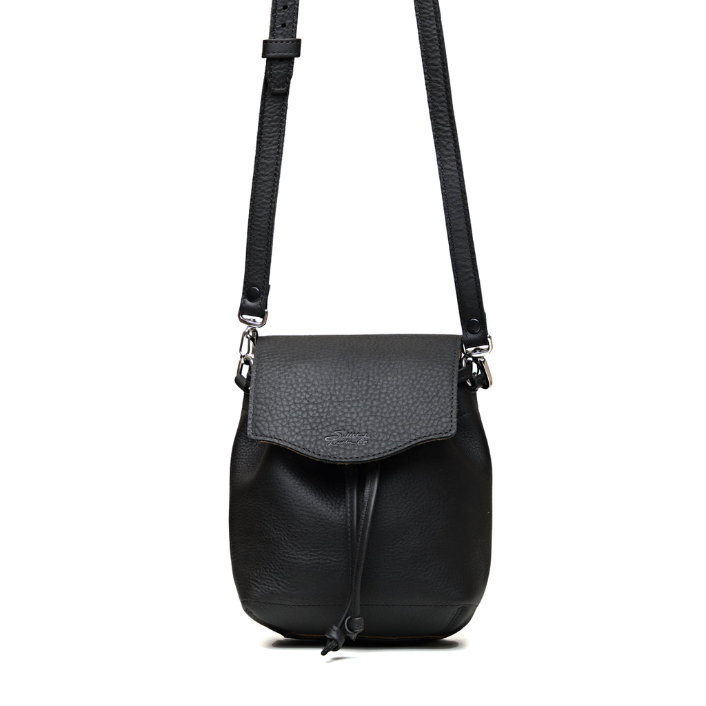 Mini Bucket Bag in Black, front view with flap, drawstring tie and adjustable crossbody strap