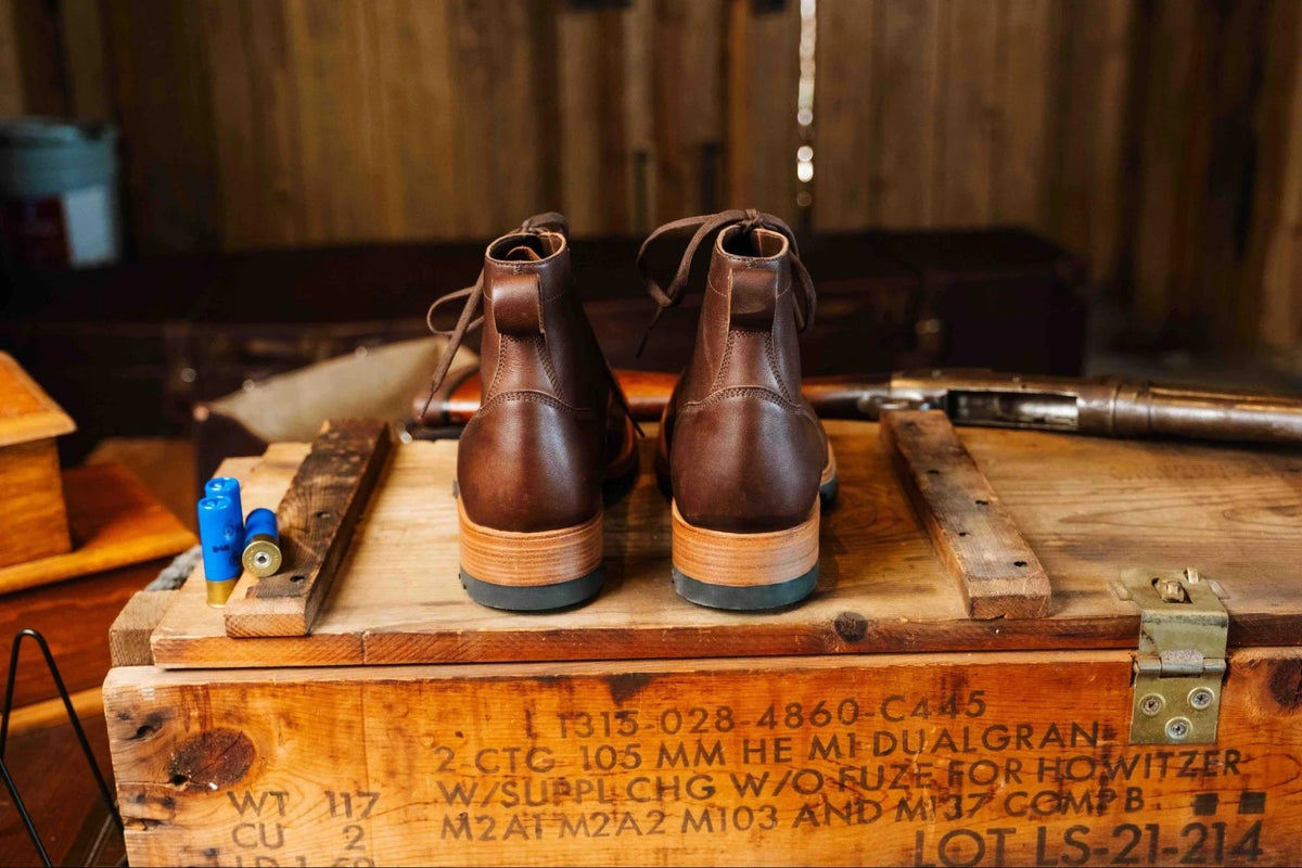 Huntsman Boots - Dark Coffee Brown, back view of a pair showing the stacked heels on a stenciled wooden crate