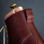 Officer Boot in Oxblood, close-up of heel stitching and pull tab with shoe tree