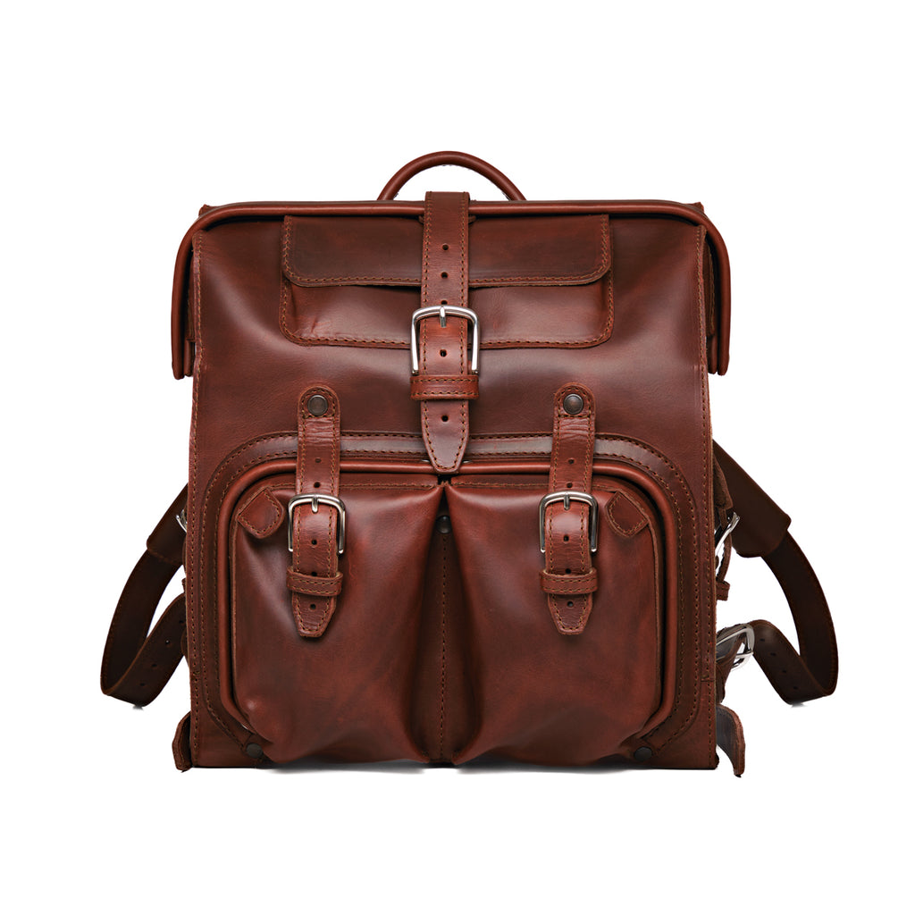 Big Mouth Leather Backpack in Chestnut, front view with buckled pockets and top handle