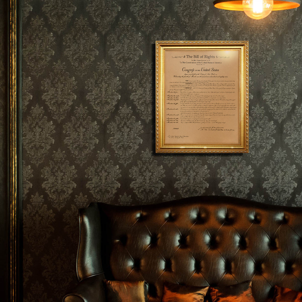 Leather Bill of Rights - Natural in a gold frame on damask wallpaper above a tufted leather sofa