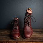 Officer's Boot in Oxblood, pair with dark laces and shoe trees, one boot raised on a stand
