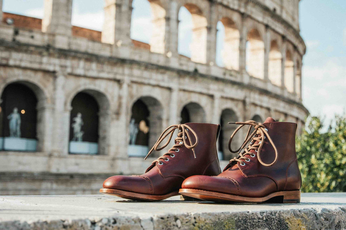 Officer's Boot in Oxblood, pair on a stone ledge in front of the Colosseum in Rome