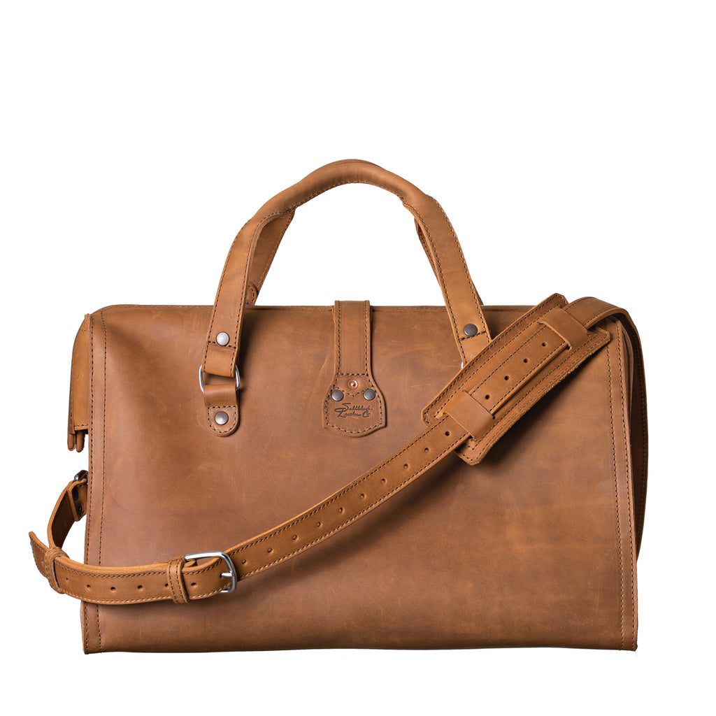 Deep Pocket Leather Duffle Bag in Tobacco, back view with handles and shoulder strap draped across
