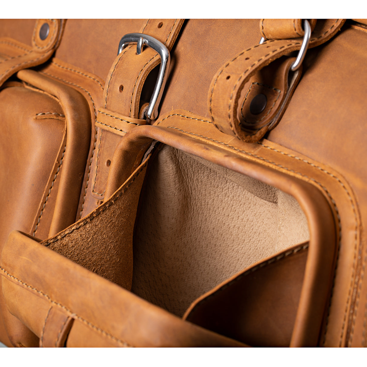 Deep Pocket Leather Duffle Bag in Tobacco, close-up of an open front pocket with suede lining and buckles