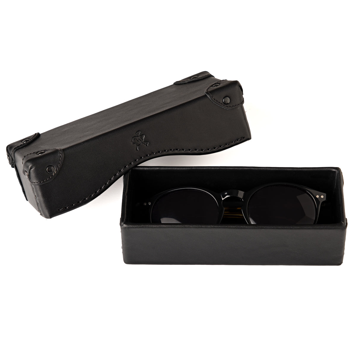 Grandfather Eyeglass Case in Black leather, open with a pair of round sunglasses inside and lid beside it