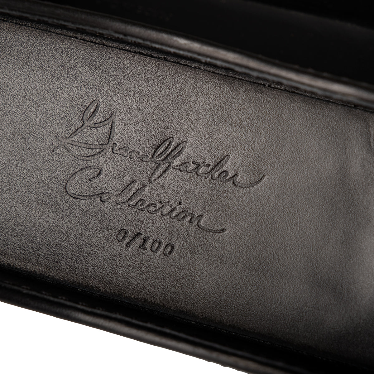 Grandfather Eyeglass Case in Black leather, close-up of embossed Grandfather Collection script and edition number