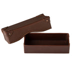 Grandfather Eyeglass Case in Chestnut leather, lid set beside the open base, embossed tortoise on top