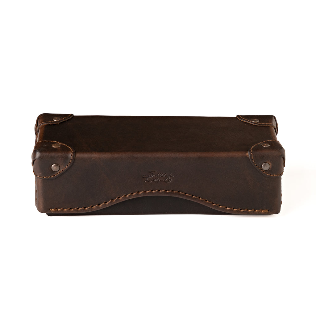 Grandfather Eyeglass Case in Dark Coffee Brown, closed front view with riveted corner caps and embossed logo