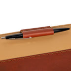 Old Design Medium Leather Portfolio in Chestnut, close-up of the leather pen loop holding a pen