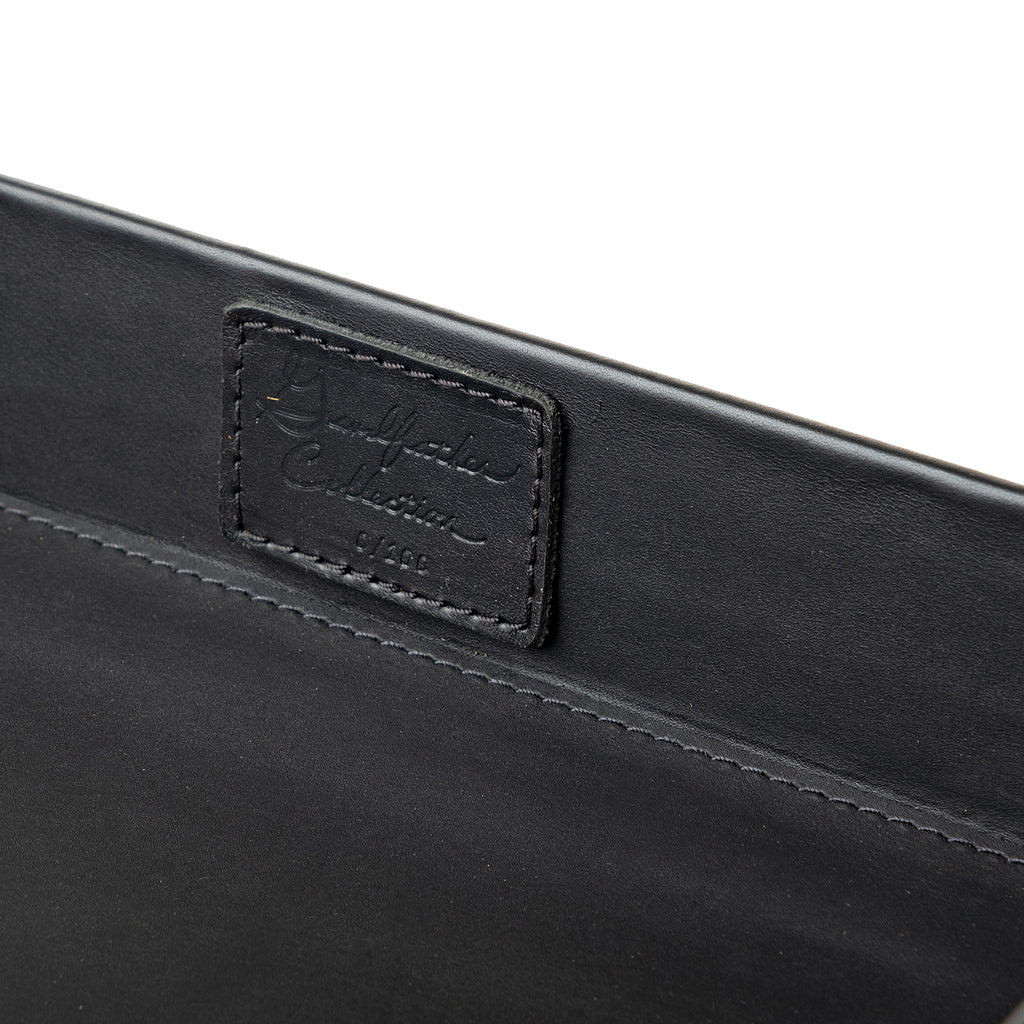 Grandfather Serving Tray in Black leather, close-up of stitched Grandfather Collection patch on the inner wall