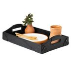 Grandfather Serving Tray in Black leather holding a plate, wooden utensils, a terracotta cup and a potted succulent