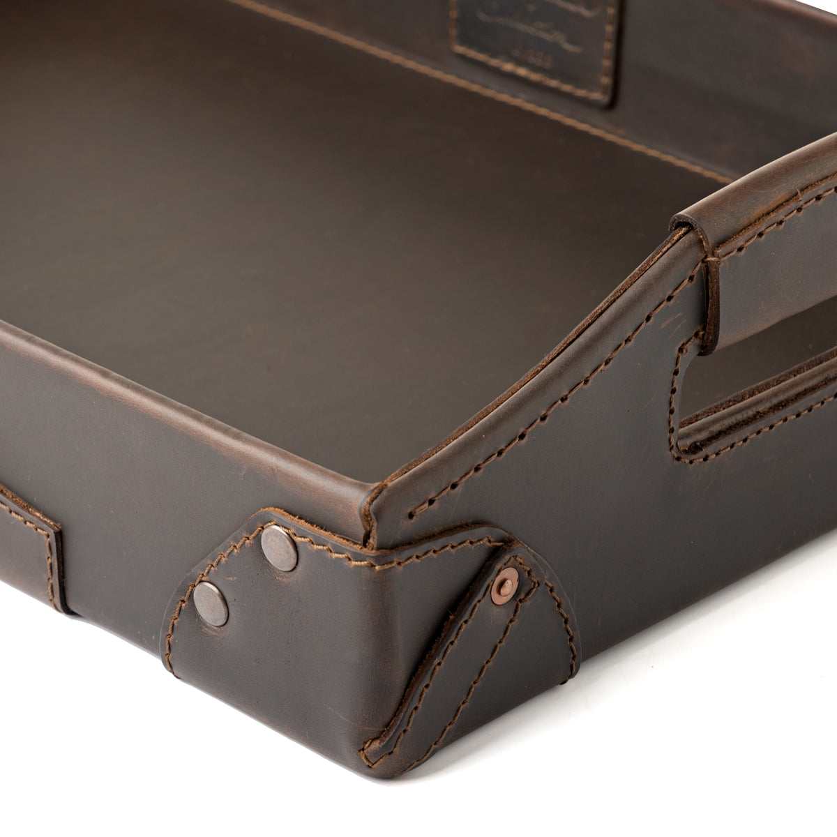 Grandfather Serving Tray in Dark Coffee Brown leather, close-up of riveted corner, stitching and handle
