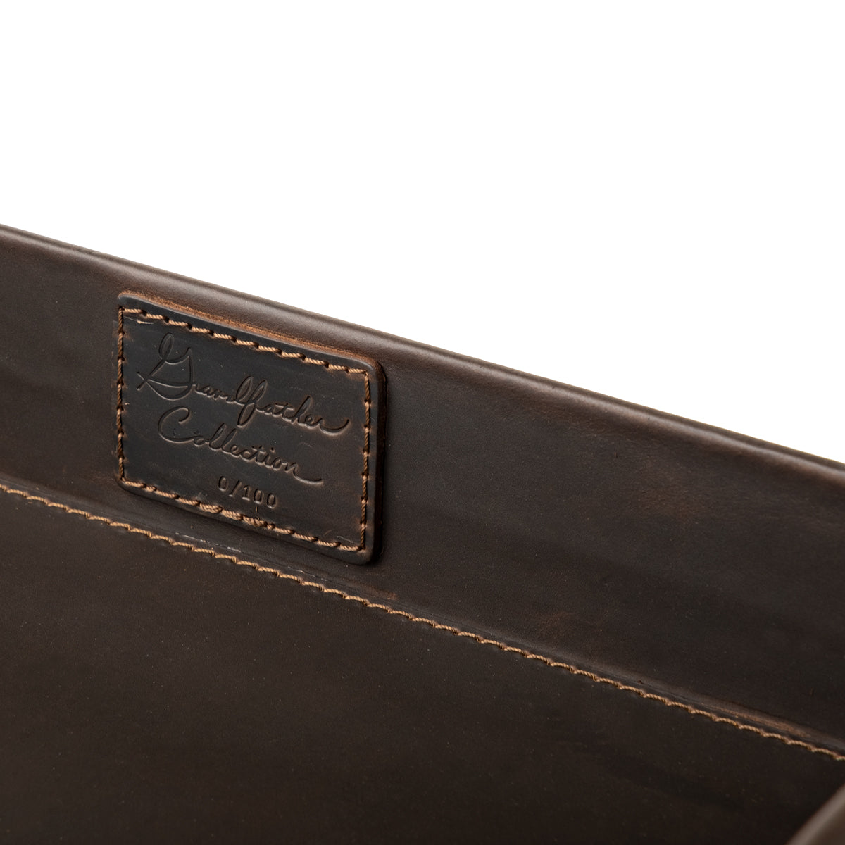 Grandfather Serving Tray in Dark Coffee Brown, close-up of stitched Grandfather Collection patch on the inner wall