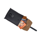 Leather Travel Satchel in Black, top view with flap open showing a wallet, cards, coins and a booklet inside