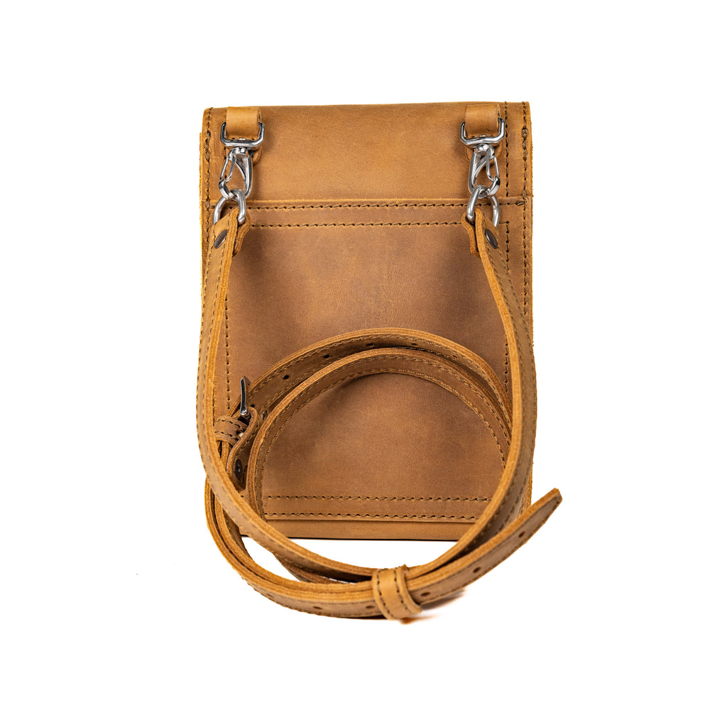 Leather Travel Satchel in Tobacco, back view with removable shoulder strap clipped to swivel hooks