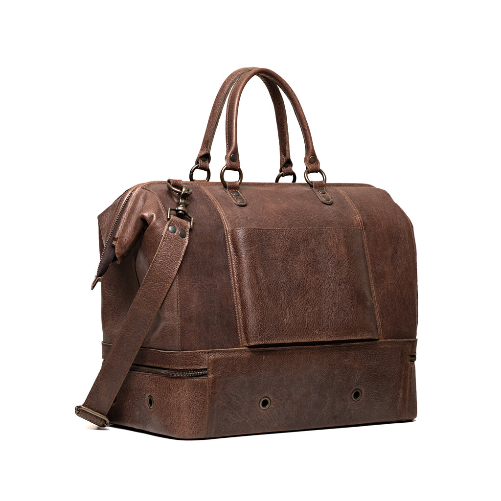 Two Compartment Duffle in Dark Coffee Brown, angled back view with trolley sleeve and vented bottom compartment