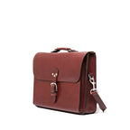Livingstone Briefcase in Oxblood, angled side view showing the buckled flap and shoulder strap clip