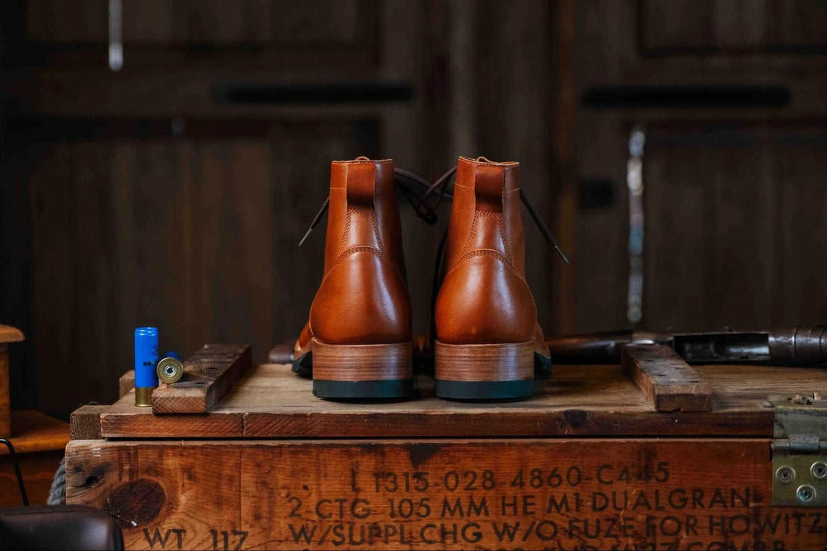 Huntsman Boots - Natural, back view of a pair showing the stacked leather heels on a stenciled wooden crate
