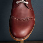 Officer Boot in Oxblood, close-up of cap toe with brogue perforations and welt stitching