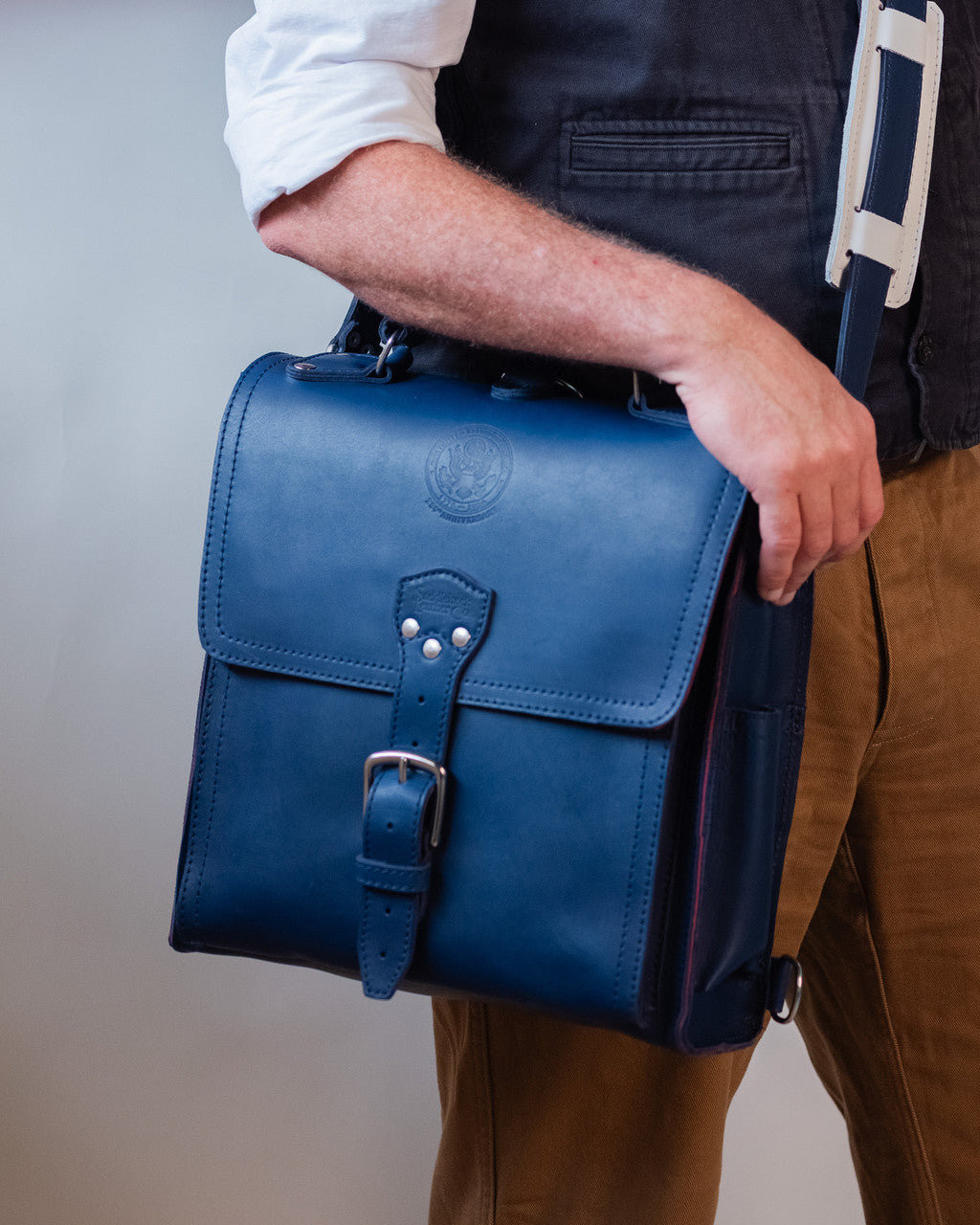 Saddleback Club Membership Paul Revere Leather Messenger Bag Backpack in Red, White and Blue, worn at the hip on shoulder strap