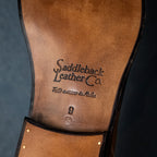 Leather sole of a high quality black leather Officer Boot stamped Saddleback Leather Co., bottom view