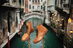 Officer's Boot in English Tan, pair on wooden stands above a Venice canal