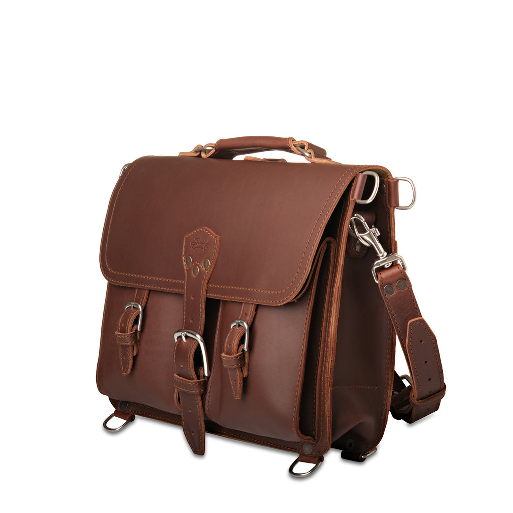 Thin Front Pocket Leather Briefcase in Chestnut, angled front view with two buckled front pockets and shoulder strap