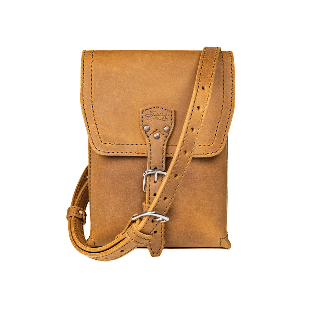 Leather Travel Satchel in Tobacco, front view with adjustable shoulder strap draped across the bag