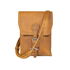 Leather Travel Satchel in Tobacco, front view with adjustable shoulder strap draped across the bag