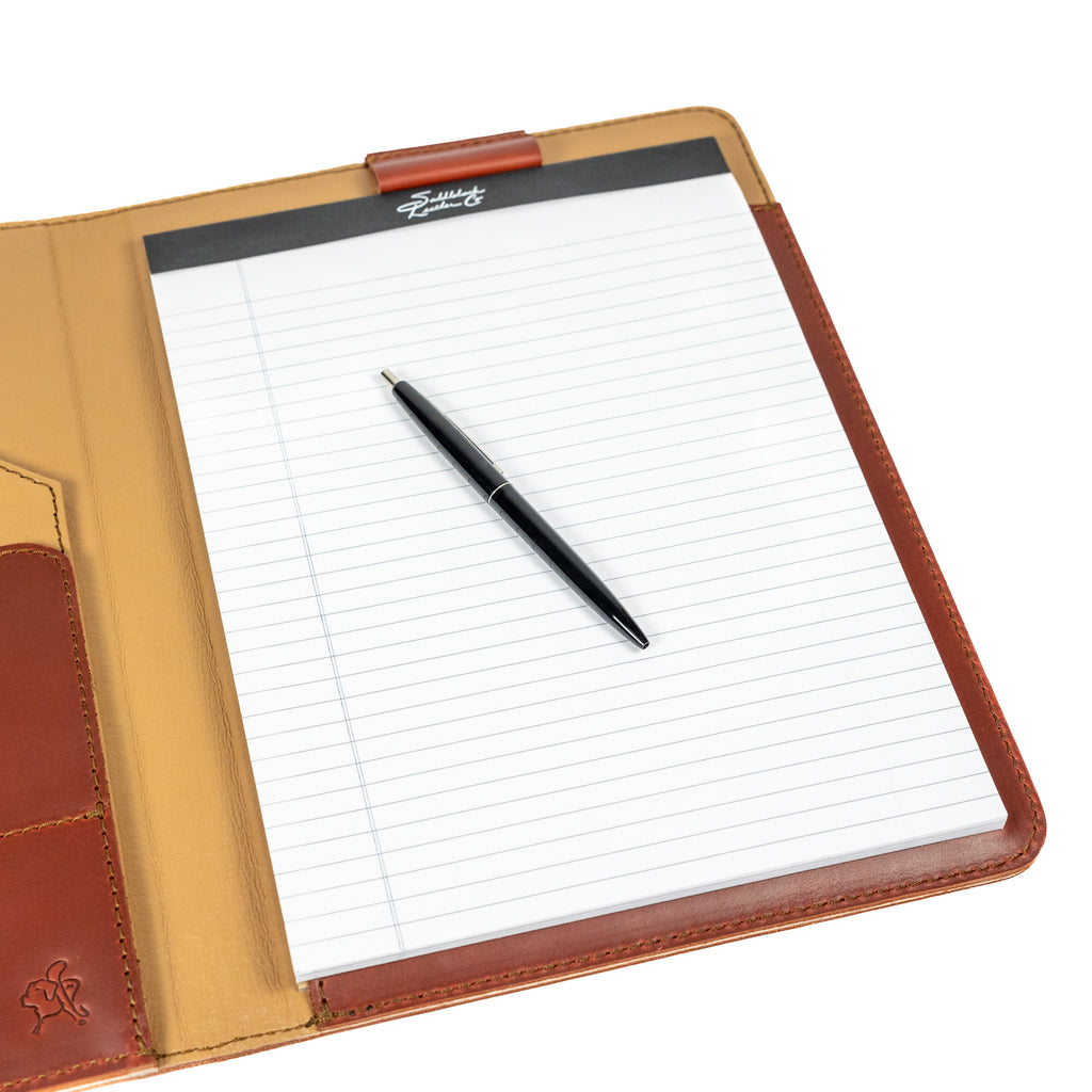 Old Design Medium Leather Portfolio in Chestnut, open with a legal pad and pen, angled close-up