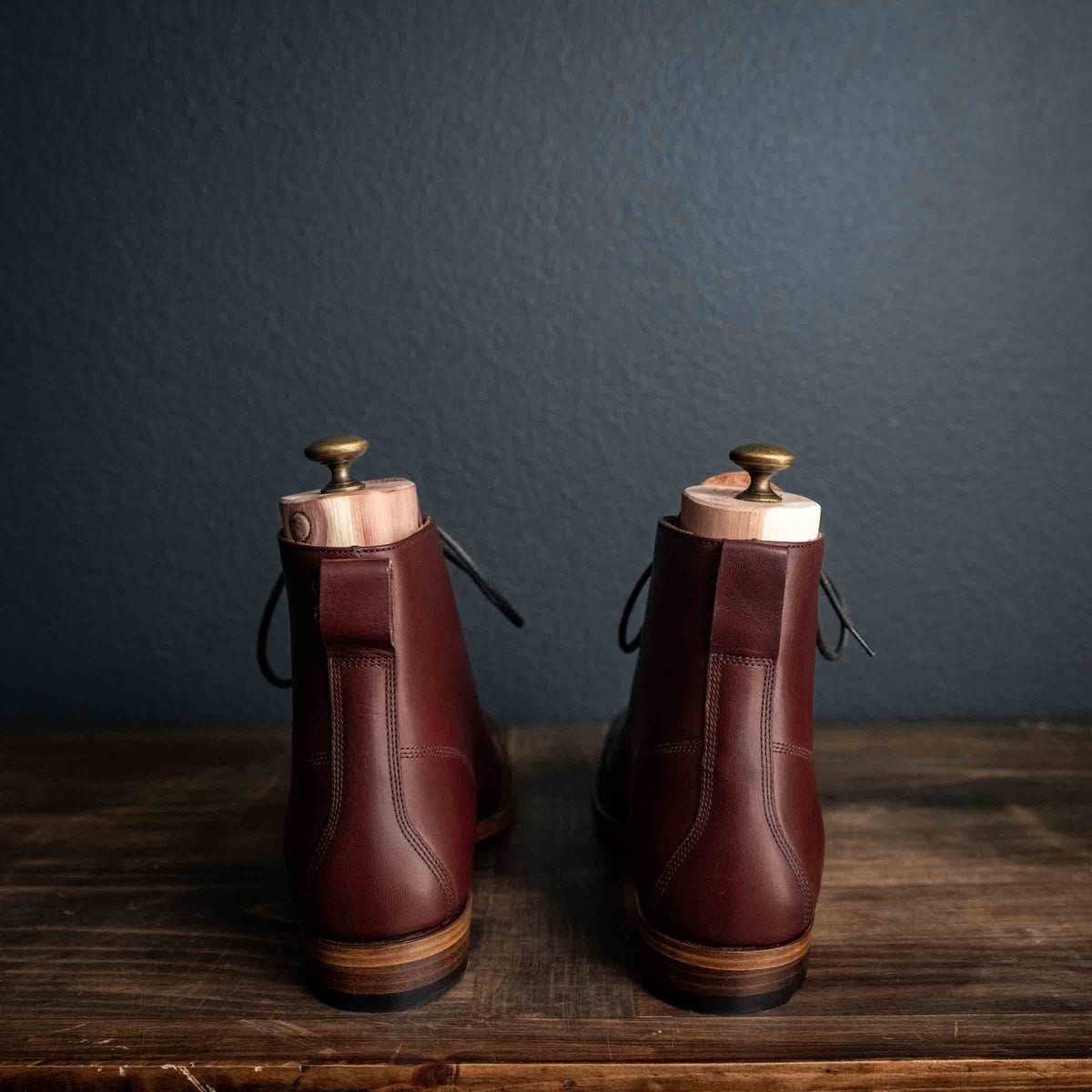Officer's Boot in Oxblood, back view of the pair with pull tabs and shoe trees