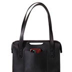 Professional Leather Tote in Black, close-up front view of shoulder handles and a phone in the front pocket