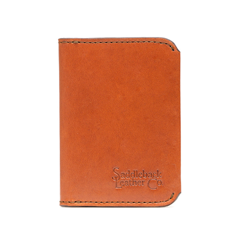 Closed tan leather slim bifold wallet with rounded corners and dark edge stitching.
