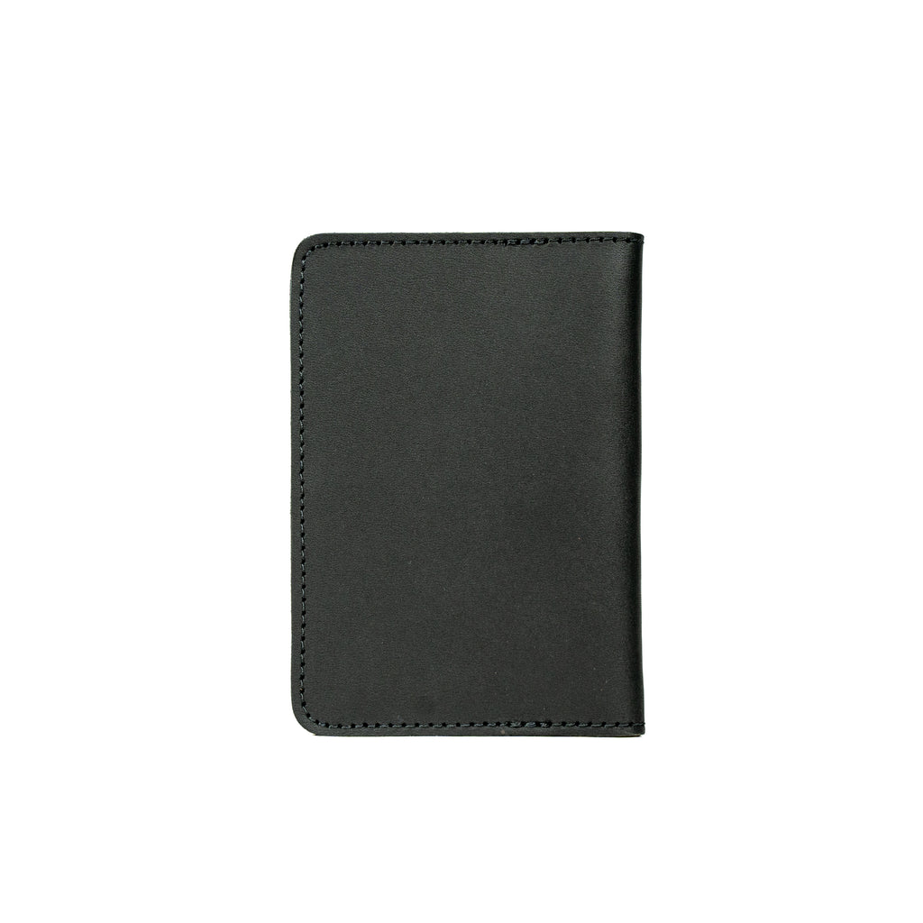 Slim Passport Wallet in Black, closed back view with stitched edges and rounded corners