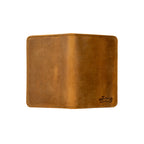 Slim Passport Wallet in Tobacco opened flat face down, showing the full outer cover and embossed logo