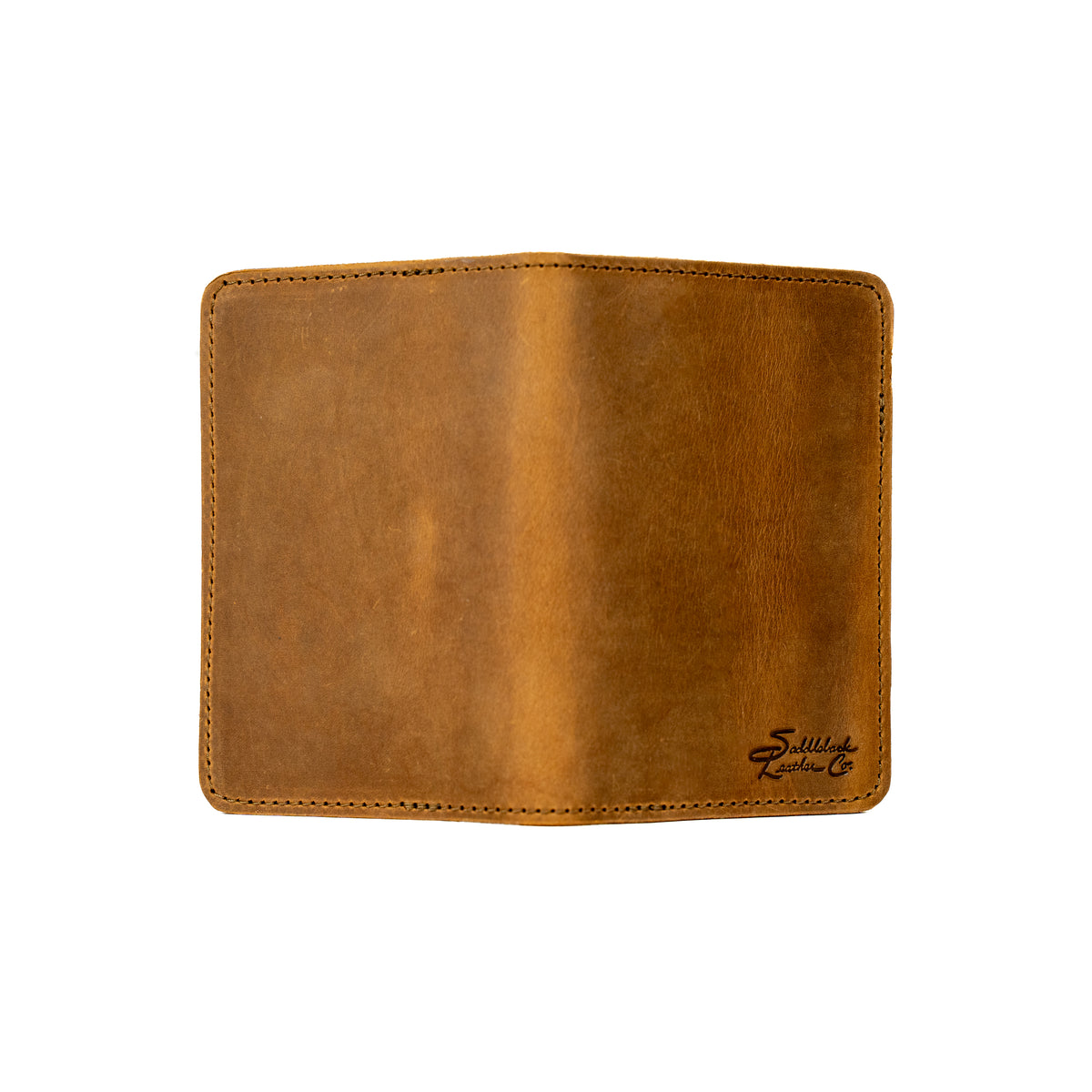 Slim Passport Wallet in Tobacco opened flat face down, showing the full outer cover and embossed logo