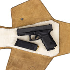 Leather Pistol Wrap in Tobacco laid open to show the fleece lining with a handgun and spare magazine