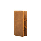 Large Magic Wallet in Tobacco standing upright and closed, showing the tall slim profile and side straps