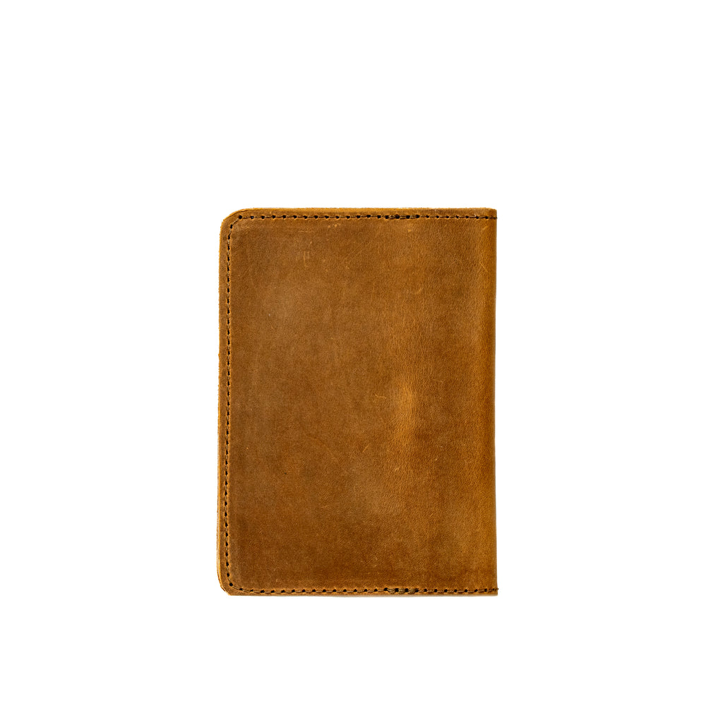 Slim Passport Wallet in Tobacco, closed back view with stitched edges and rounded corners