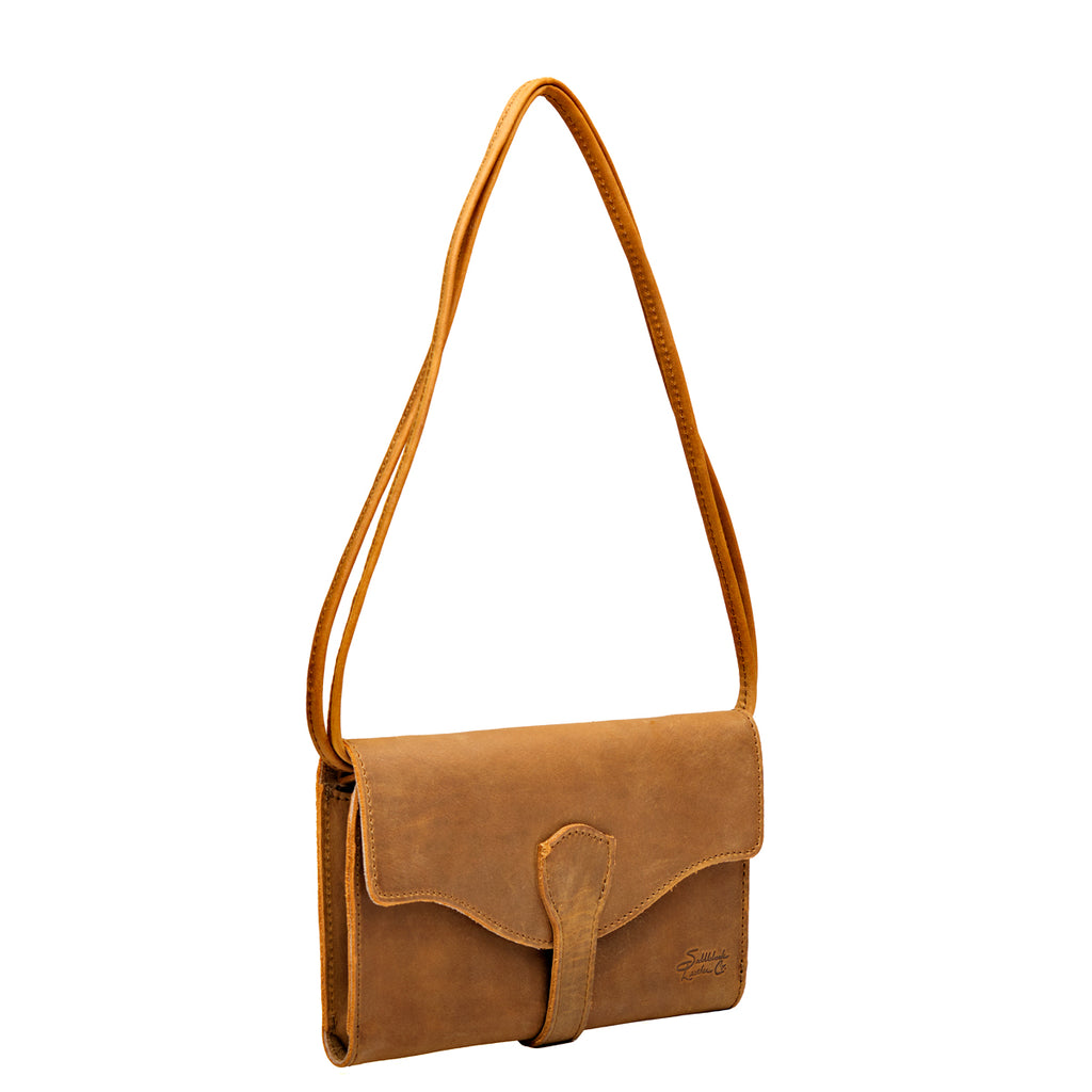 On The Go Leather Wallet in Tobacco hanging from its thin leather shoulder strap, angled view