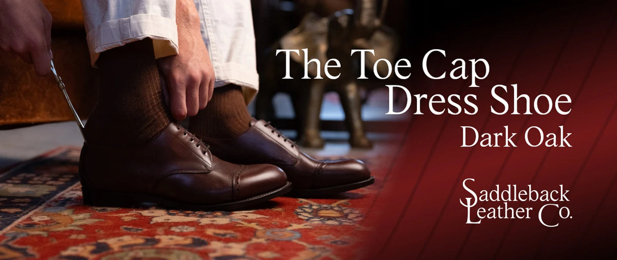 Toe Cap Shoes - Dark Oak being put on with a shoehorn, banner text The Toe Cap Dress Shoe Dark Oak