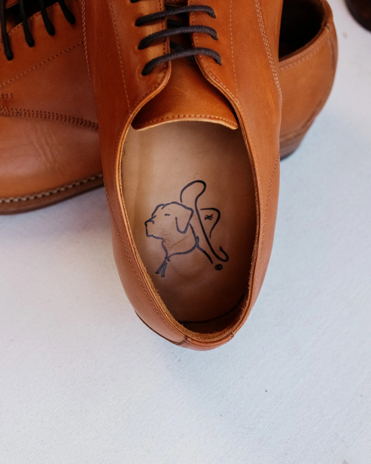 Toe Cap Shoes - English Tan, close-up of the leather insole stamped with the Saddleback dog logo