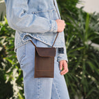Walker's Pouch in dark brown, worn crossbody at the hip with a denim jacket and jeans