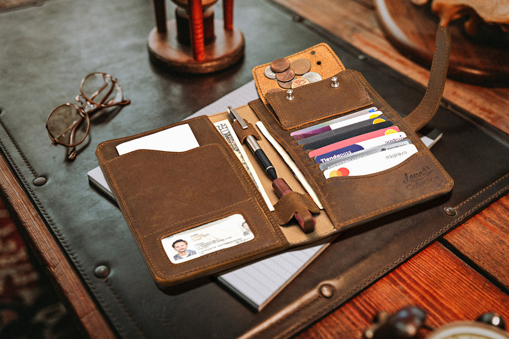 New Big Wallet in Tobacco open on a desk pad beside eyeglasses and an hourglass