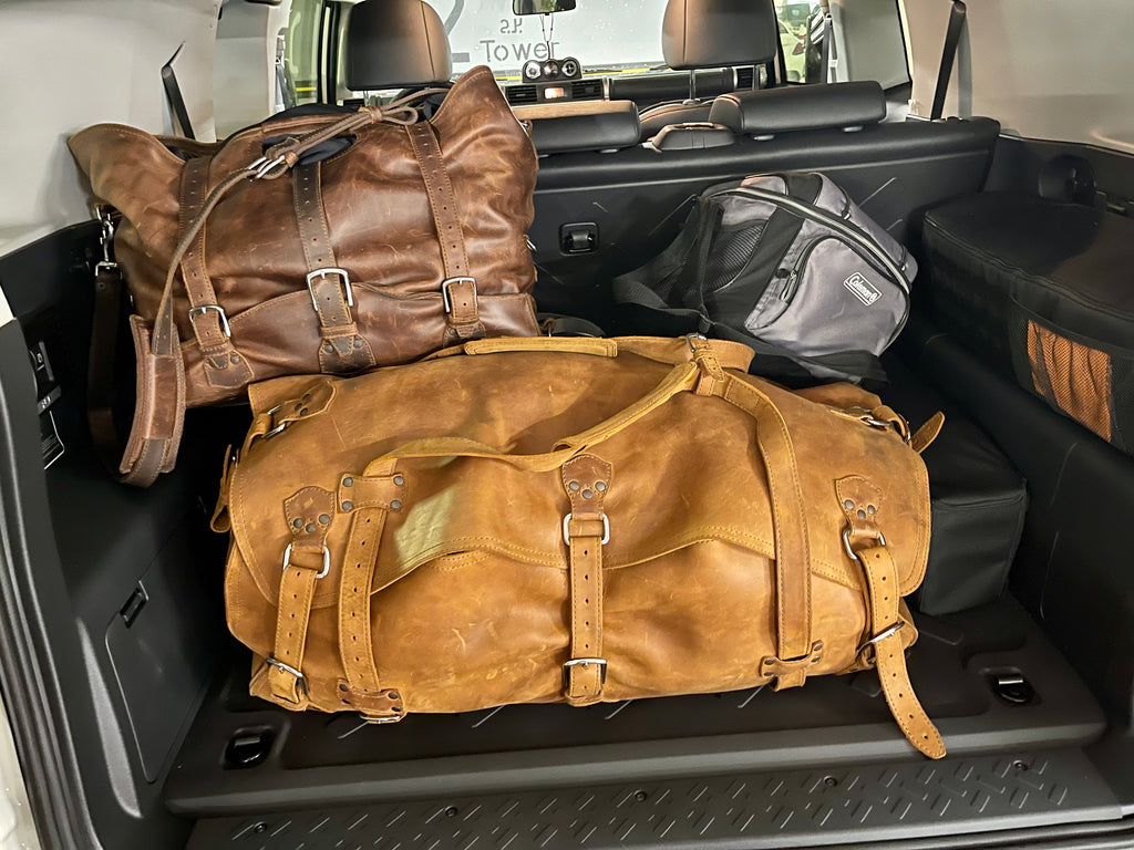 20" Waterbag in Tan with a Chestnut Waterbag behind it, packed in an SUV cargo area